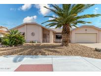 Single-story home with desert landscaping and a two-car garage at 18003 N 136Th Way, Sun City West, AZ 85375