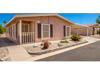 Tan single-wide manufactured home with carport and small front yard at 2400 E Baseline Ave # 84, Apache Junction, AZ 85119