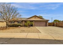 Charming single-story home featuring a desert-landscaped front yard and a spacious two-car garage at 3000 E Tulsa St, Gilbert, AZ 85295