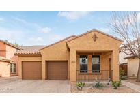 Tan two-story house with brown garage door and small front porch at 3923 E Kesler Ln, Gilbert, AZ 85295