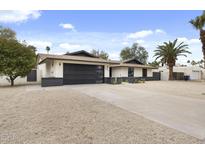 Charming single-story home with a modern garage door and well-maintained desert landscaping at 4059 E Cholla St, Phoenix, AZ 85028