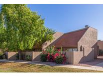 Charming townhome featuring desert landscaping with mature trees and red tiled roof at 7326 N 43Rd Ave, Glendale, AZ 85301