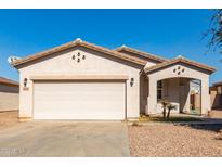 One-story house with a two-car garage and desert landscaping at 7420 W Glass Ln, Laveen, AZ 85339