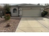 Charming single Gathering home with neutral paint, two-car garage, and low maintenance desert landscaping at 9131 W Boca Raton Rd, Peoria, AZ 85381