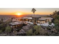 Stunning aerial view of a modern home with city views at sunset at 13801 N Moon Dr, Phoenix, AZ 85023