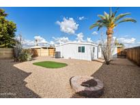 Backyard features artificial turf, fire pit, and gravel at 16230 N 35Th Way, Phoenix, AZ 85032