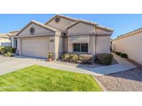 Well-maintained house with a two-car garage and manicured lawn at 17065 N Silver Path, Surprise, AZ 85374