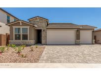Charming single-story home with a stone-accented facade, paver driveway, and well-maintained landscaping at 18219 W Hess St, Goodyear, AZ 85338