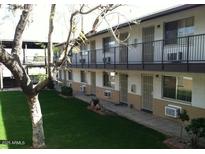 Apartment building with grassy courtyard and covered walkways at 1945 W Sweetwater Ave # 2013, Phoenix, AZ 85029