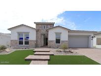 Beautiful single-story home featuring stone accents, manicured lawn and a spacious two car garage at 20233 W San Miguel Ave, Litchfield Park, AZ 85340