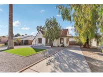 Charming, light-colored, single-story home with well-kept yard and long driveway at 2209 E Weldon Ave, Phoenix, AZ 85016