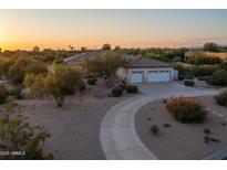 Desert home with three-car garage and circular driveway at 26846 N 73Rd St, Scottsdale, AZ 85266