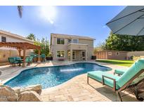 Inviting backyard with sparkling pool, patio furniture, and pergola at 3210 E Brookwood Ct, Phoenix, AZ 85048