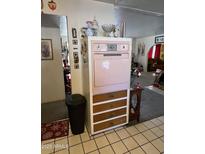 Retro kitchen features vintage stove and ample wood cabinetry at 4402 W Verde Ln, Phoenix, AZ 85031