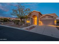 Desert landscape surrounds this charming one-story home with a two-car garage at 6403 S Fairway Dr, Gold Canyon, AZ 85118