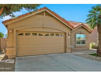 Tan two-story house with a two-car garage and desert landscaping at 8947 E Mescal St, Scottsdale, AZ 85260