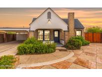 Charming craftsman bungalow with brick facade, updated landscaping, and a spacious driveway at 1696 E Amelia Ave, Phoenix, AZ 85016