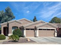 Beautiful single-story home with a two-car garage and desert landscaping at 18176 W Paradise Ln, Surprise, AZ 85388