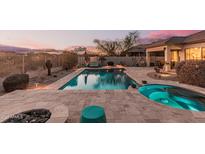 Stunning backyard with a large pool, spa, and fire pit at 18193 W Buckhorn Dr, Goodyear, AZ 85338