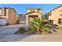 Two-story house with desert landscaping and a two-car garage at 18536 W Douglas Way, Surprise, AZ 85374