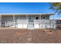 Gray mobile home with covered porch and ramp access at 2650 W Union Hills Dr # 231, Phoenix, AZ 85027