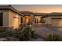 Elegant single-story home with desert landscaping and a three-car garage at 3021 W Feather Sound Dr, Phoenix, AZ 85086