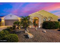 Stunning desert home exterior at sunset, showcasing a landscaped yard and attractive architectural details at 3311 N 150Th Dr, Goodyear, AZ 85395