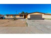 Ranch style home with a two-car garage and large front yard at 3726 W Coolidge St, Phoenix, AZ 85019