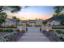 Stunning modern farmhouse exterior with stone accents and landscaped grounds at 6109 E Maverick Rd, Paradise Valley, AZ 85253