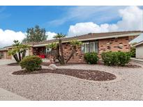 Charming single-story brick home with a well-maintained desert front yard at 7950 E Lakeview Ave, Mesa, AZ 85209