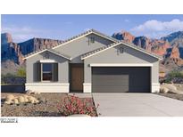 Single-story home with gray exterior, two-car garage, and desert landscaping at 9699 S Mara Dr, Apache Junction, AZ 85120