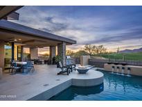 Luxury backyard oasis with a fire pit, pool, and mountain views at 10598 E Fernwood Ln, Scottsdale, AZ 85262