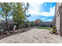 Landscaped backyard with artificial turf and patio at 1631 N Beverly --, Mesa, AZ 85201