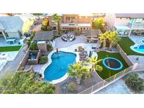 Aerial view of a luxury home with a large backyard, pool, and multiple entertainment areas at 18212 W East Wind Ave, Goodyear, AZ 85338