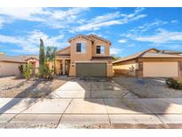 Two-story house with a green garage door and desert landscaping at 2119 W Vineyard Plains Dr, San Tan Valley, AZ 85144