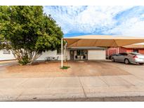 Ranch style home with carport and landscaped front yard at 2206 W Glendale Ave, Phoenix, AZ 85021