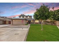 Two-story house with a landscaped lawn and attached garage at 2238 S Estrella Cir, Mesa, AZ 85202