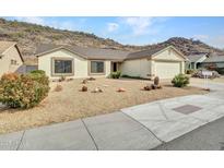 Single-story home with desert landscaping and a two-car garage at 22667 N 30Th Ave, Phoenix, AZ 85027