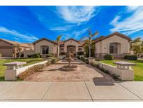 Stunning home featuring an inviting entrance, mature palms, stone accents, and lush landscaping at 2939 E Huber St, Mesa, AZ 85213