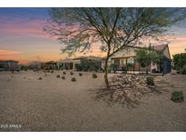 Desert landscape with fenced patio and covered seating area at 36168 N Stoneware Dr, Queen Creek, AZ 85140