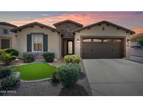 Single-story home with front yard and two-car garage at 36168 N Stoneware Dr, Queen Creek, AZ 85140