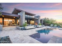 Modern home with pool and landscaped backyard; expansive patio and stunning sunset views at 38484 N 94Th St, Scottsdale, AZ 85262