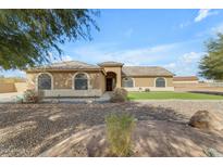 One-story house with a landscaped lawn and a large driveway at 3936 E Ascot Dr, San Tan Valley, AZ 85140