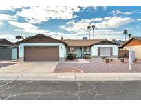 Single-story home with a two-car garage and landscaped front yard at 5331 W Mescal St, Glendale, AZ 85304