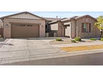 Charming single-Gathering home featuring a stone facade and a two-car garage at 5724 S Coyote Cyn, Mesa, AZ 85212