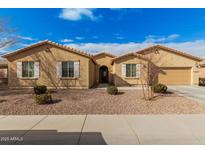 Single-story home with a tan facade, white shutters, and a landscaped front yard at 5836 S 58Th Gln, Laveen, AZ 85339