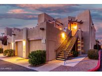 Tan two-story stucco home with a metal staircase and attached garage at 7021 E Earll Dr # 213, Scottsdale, AZ 85251