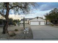 Single-story home with desert landscaping and a three-car garage at 9546 E Anasazi Pl, Gold Canyon, AZ 85118