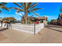 Charming bungalow with a white picket fence and beautiful landscaping at 1002 E Palm Ln, Phoenix, AZ 85006