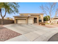 Two-story house with three-car garage, landscaping, and a large driveway at 1078 W Spur Ct, Gilbert, AZ 85233